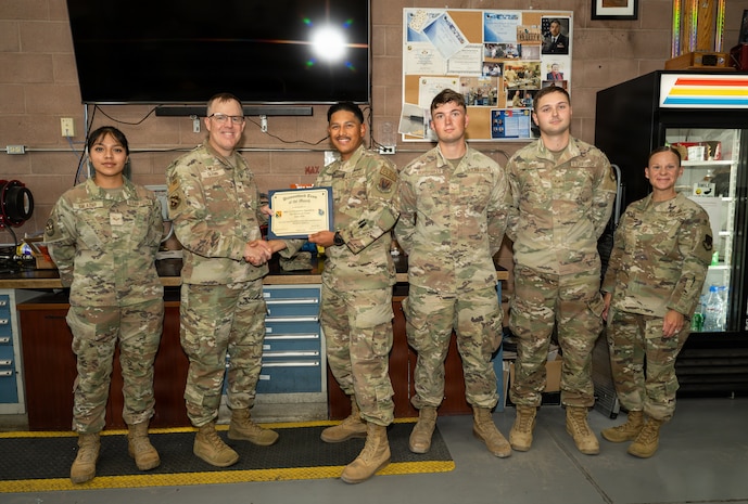 Group of people posing with certificate