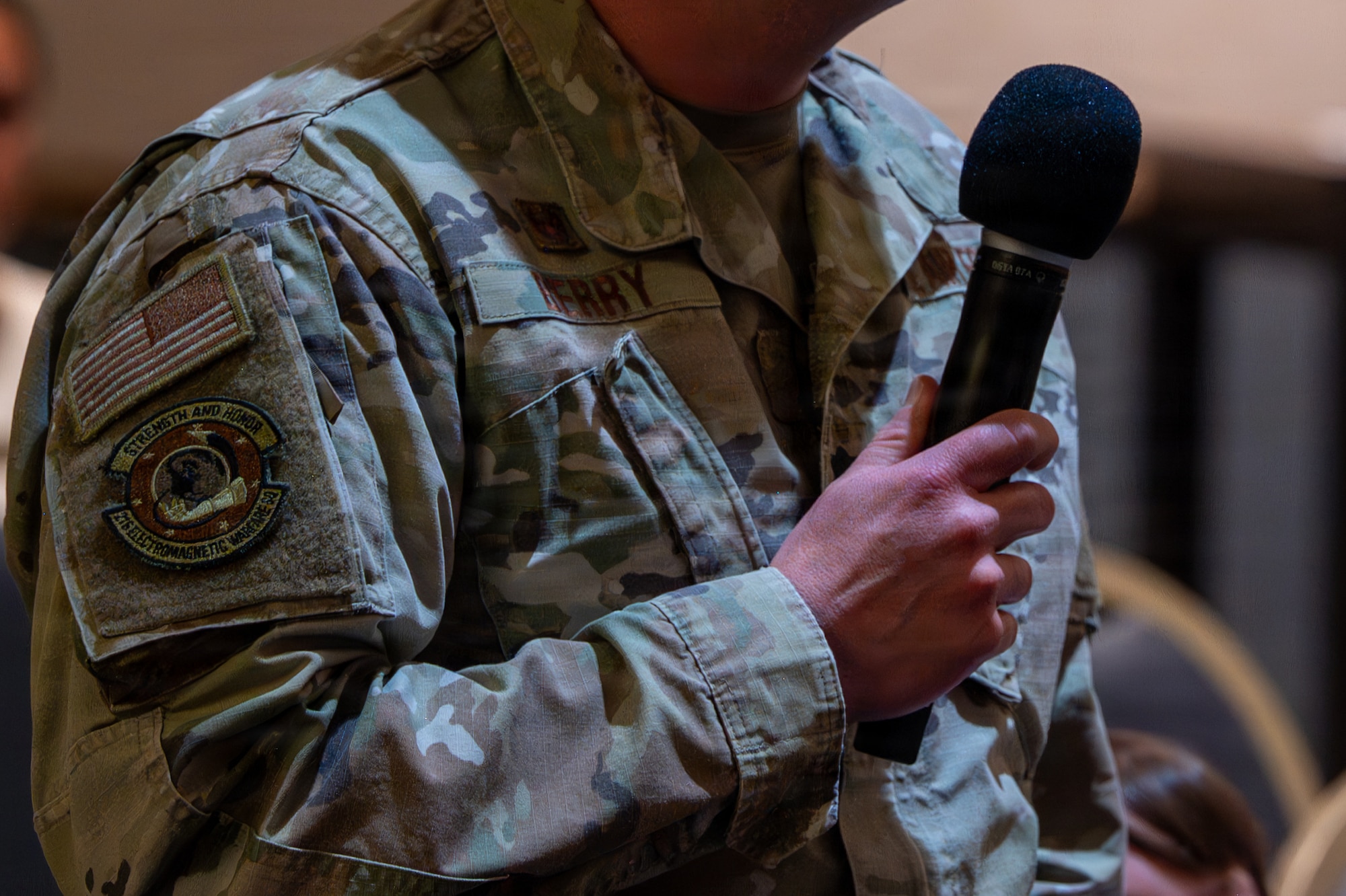A person holds a microphone