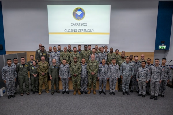 Service members from the U.S. Navy, U.S. Coast Guard, Royal Canadian Navy, and Royal Thai Navy pose for a group photo during the closing ceremony of exercise Cooperation Afloat Readiness and Training (CARAT) Thailand 2026.