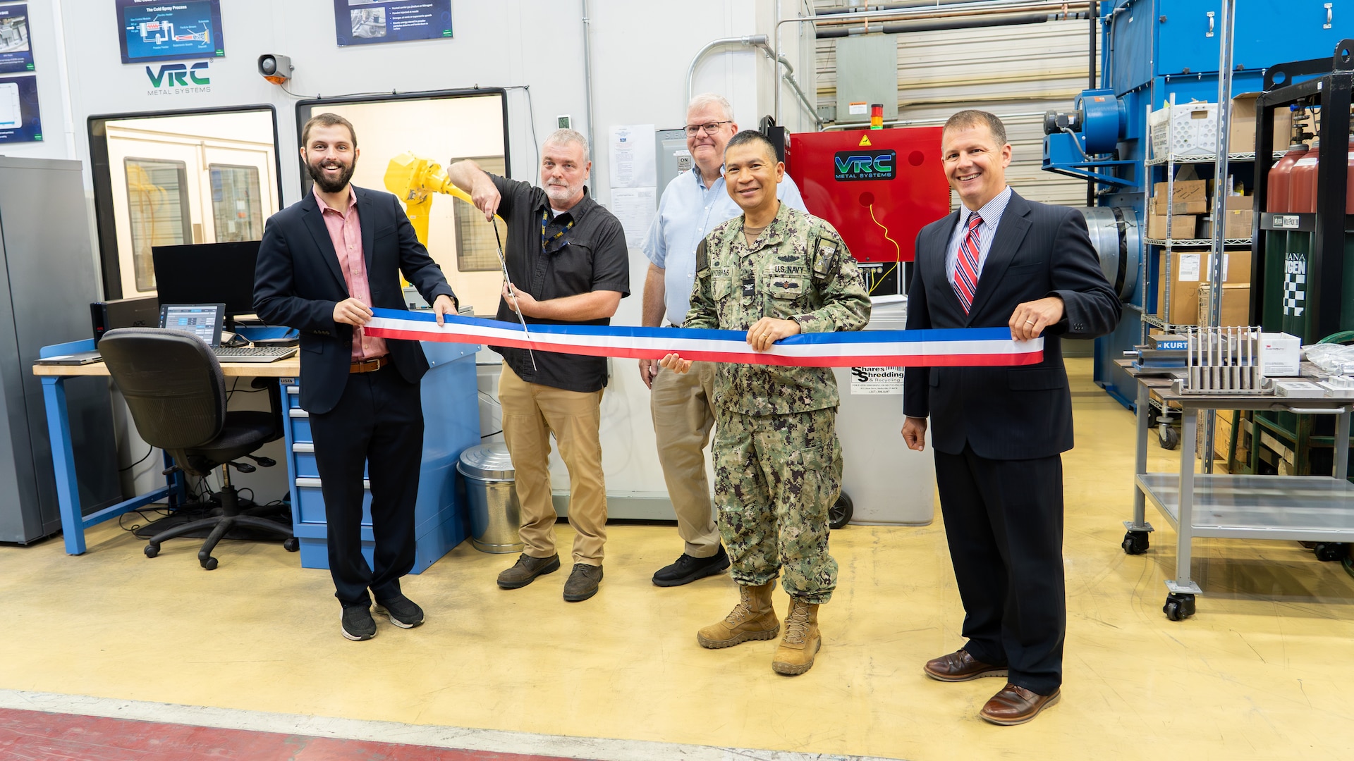 Figure 1: Pictured left to right, Troy Pierson, Director, MADMAN Repair Center, Scott Gamble, Mechanical and Materials Rapid Prototype Branch Manager, Jeff Campbell, NAVSEA 05T1, Cold Spray Project Manager, Capt. Boonyobhas, NSWC Crane Commanding Officer, and Dr. Werner, NSWC Crane Deputy Technical Director.
