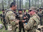 Virginia Army National Guard Soldiers assigned to the Staunton-based 116th Mobile Brigade Combat Team, Arkansas National Guard Soldiers and Guatemalan service members partnered with Arkansas through the Department of War National Guard Bureau State Partnership Program move into the field June 8, 2026, during a training rotation at the Joint Readiness Training Center, or JRTC, at Fort Polk, Louisiana. Brig. Gen. Rusty McGuire, senior trainer for the Virginia Army National Guard’s JRTC rotation, and senior trainer noncommissioned officer Sgt. Maj. Ian Gilliam met with the Soldiers to discuss training operations and multinational interoperability. The 116th Mobile Brigade Combat Team is the first Army National Guard brigade to participate in a JRTC rotation as a mobile brigade combat team after transitioning from an infantry brigade combat team in 2025. JRTC provides U.S. military units and personnel with complex, realistic combat training, including joint and combined-arms operations, force-on-force scenarios and live-fire exercises. Photo by Sgt. 1st Class Jeff Clements.