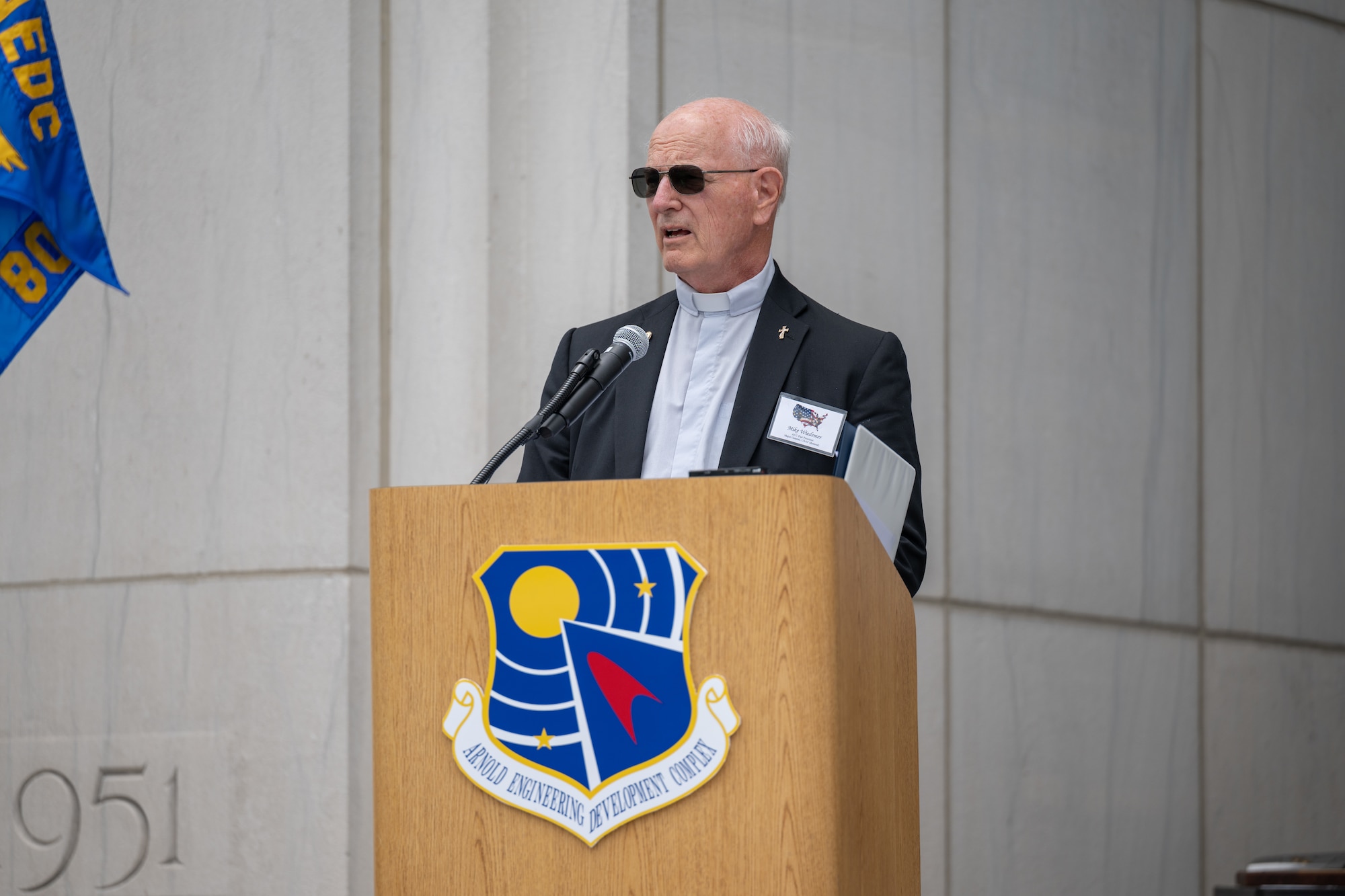 Retired Air Force Maj. Gen. and former Arnold Engineering Development Complex commander Mike Wiedemer speaks before contributing a book, a document signed by several AEDC Fellows program inductees, a written prayer and coin to the AEDC time capsule unveiled June 27, 2026, during the AEDC 75th anniversary open house celebration at Arnold Air Force Base, Tenn., headquarters of AEDC. The book contributed by Wiedemer, entitled “Architects of Air Supremacy,” describes the work of Gen. Henry “Hap” Arnold, for whom AEDC was dedicated in 1951, and Theodore von Kármán to advance American aerospace capabilities. (U.S. Air Force photo by Keith Thornburgh)