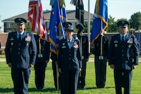 Three U.S. Air Force Colonels stand in front of The U.S. Air and Space Force Honor Guard.