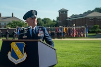 U.S. Air Force Col. stands behind a podium with The Chiefs Own symbol.