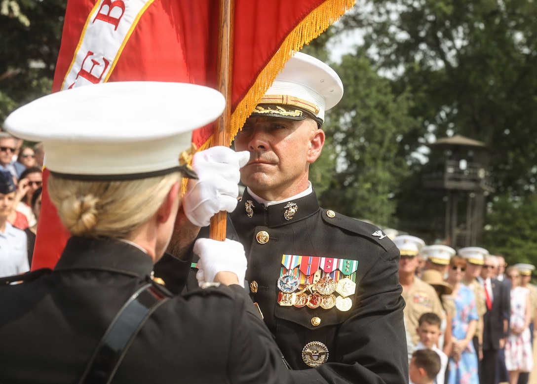 U.S. Marine Corps Col. Jason C. Copeland, incoming commanding officer of Marine Barracks Washington receives the organizational colors from Col. Carrie C. Batson, outgoing commanding officer of MBW, during a change of command ceremony at Marine Barracks Washington, D.C., July 16, 2026. The ceremony included the passing of the organizational colors from the outgoing to the incoming commander, symbolizing the transfer of authority, responsibility, and accountability for the command, and featured marching and musical elements from Marine Barracks Washington. The ceremony took place as the “Oldest Post of the Corps” celebrates 225 years since its founding, a milestone that falls during America's 250th anniversary of independence and just one year after the Marine Corps 250th birthday. (U.S. Marine Corps photo by Cpl. Brynn L. Bouchard)