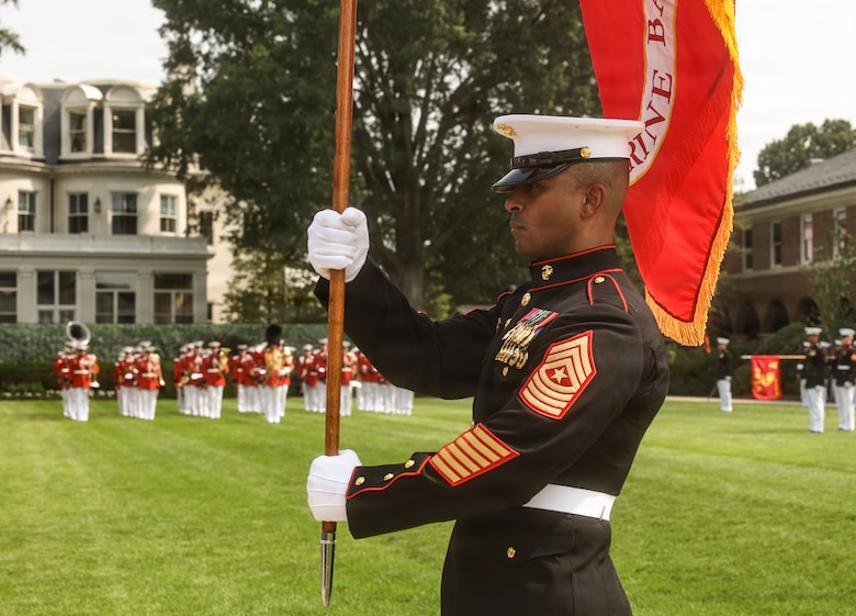 U.S. Marine Corps Sgt. Maj. Juan P. Segura, sergeant major of Marine Barracks Washington, carries the organizational colors during a change of command ceremony at Marine Barracks Washington, D.C., July 16, 2026. The ceremony included the passing of the organizational colors from the outgoing to the incoming commander, symbolizing the transfer of authority, responsibility, and accountability for the command, and featured marching and musical elements from Marine Barracks Washington. The ceremony took place as the “Oldest Post of the Corps” celebrates 225 years since its founding, a milestone that falls during America's 250th anniversary of independence and just one year after the Marine Corps 250th birthday.  (U.S. Marine Corps photo by Cpl. Brynn L. Bouchard)