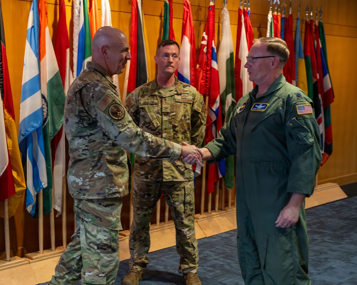 U.S. Air Force Lt. Gen. Clark J. Quinn, commander of Air Education and Training Command, coins U.S. Air Force Lt. Col. James Somerville, Air Command and Staff College academic instructor, at Maxwell Air Force Base, Alabama, June 3, 2026.