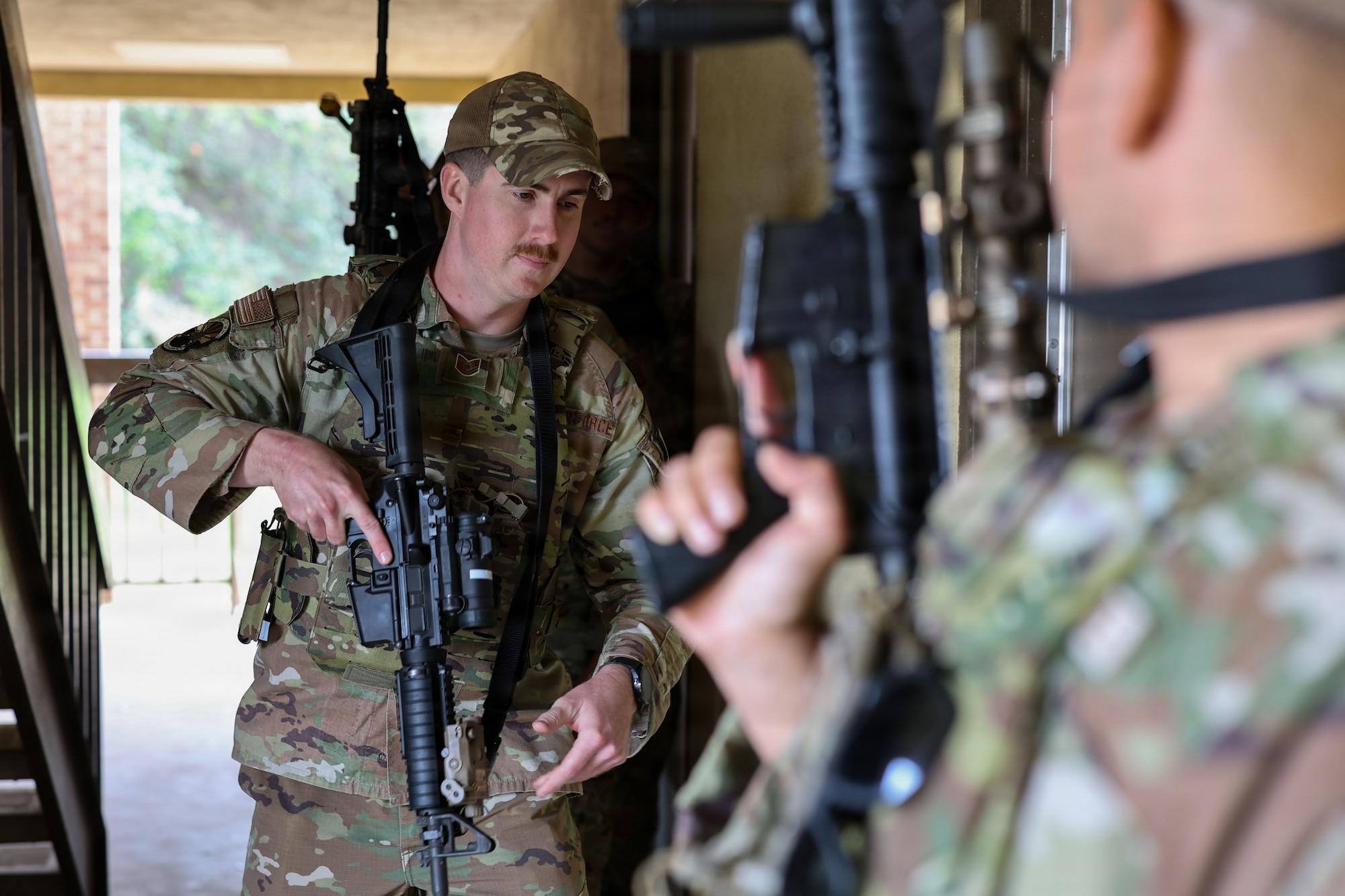 U.S. Air Force Tech. Sgt. Arthur Bunting, 82nd Security Forces Squadron noncommissioned officer in charge of pass and registration, and fellow fire team members prepare to enter a room during the close quarters combat training portion of Silent Whisper at Sheppard Air Force Base, Texas, May 1, 2026.