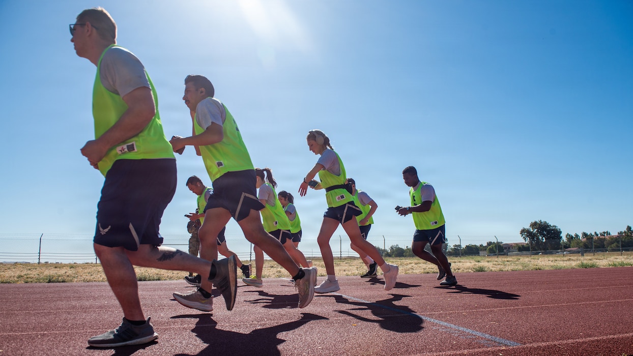 Airmen run on race track.