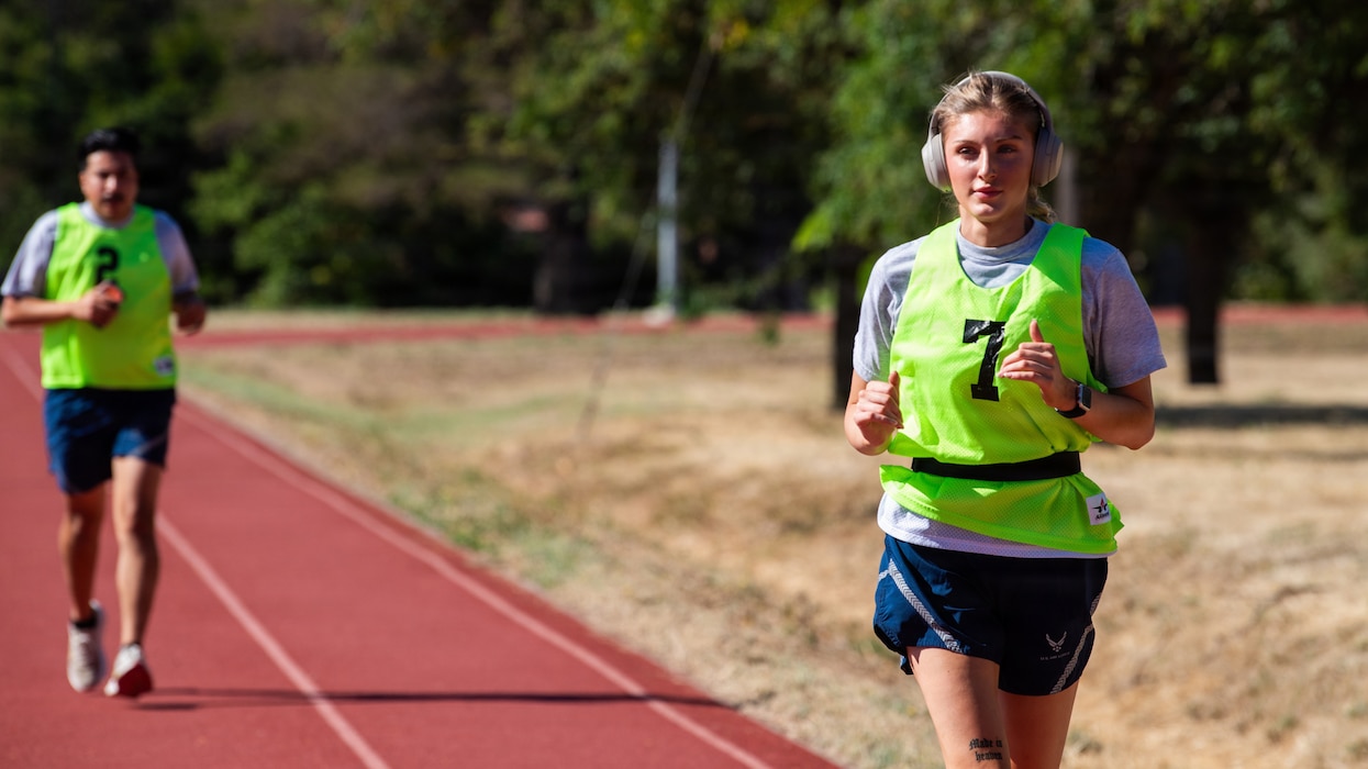 Airmen run on race track.