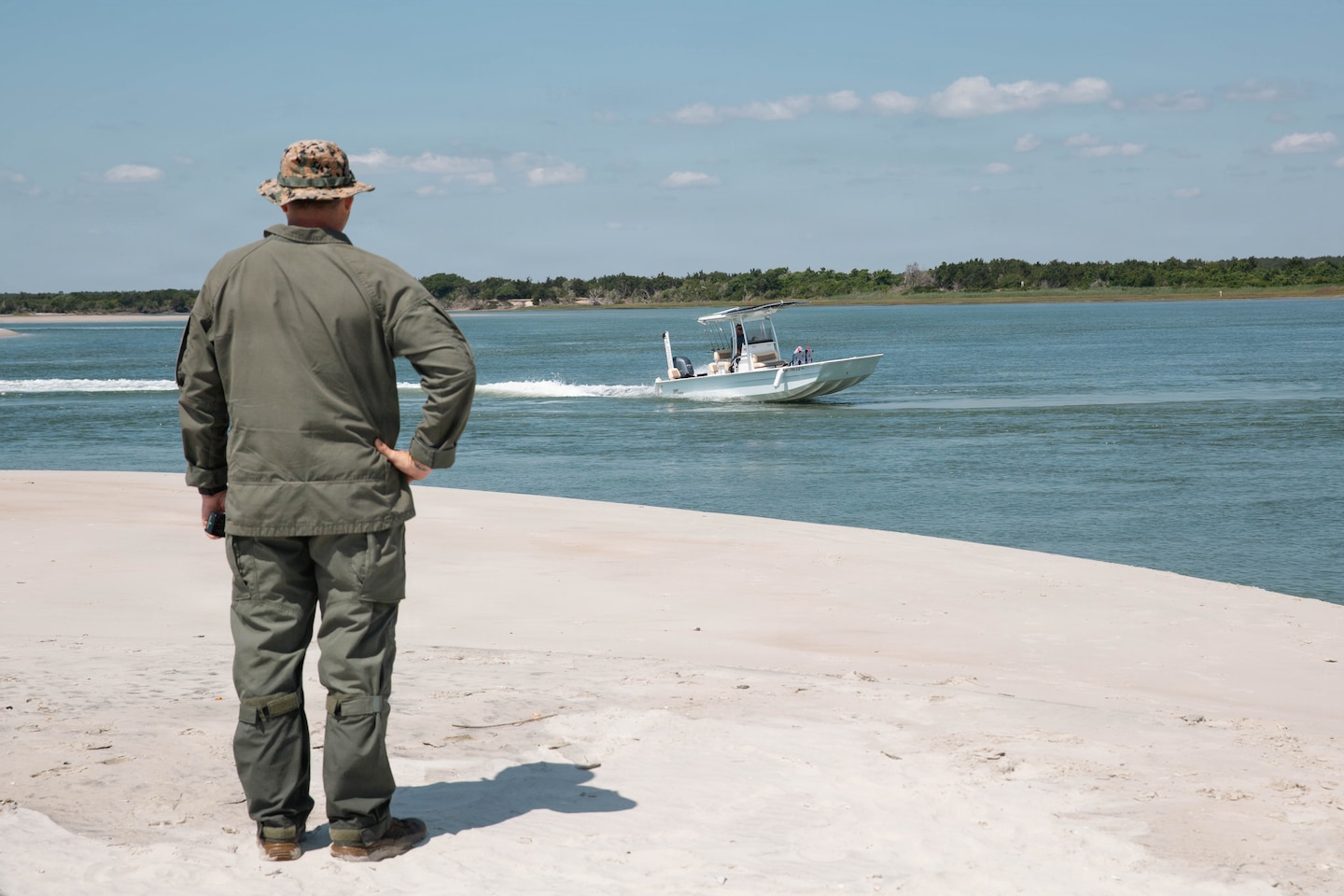 U.S. Marine Corps Master Gunnery Sgt. Craig Young, explosive ordnance disposal chief with Marine Corps Installations East-Marine Corps Base Camp Lejeune, keeps watch as a civilian watercraft passes the shoreline during a controlled demolition of unexploded ordnance on Browns Island, MCB Camp Lejeune, North Carolina, May 14, 2026.
