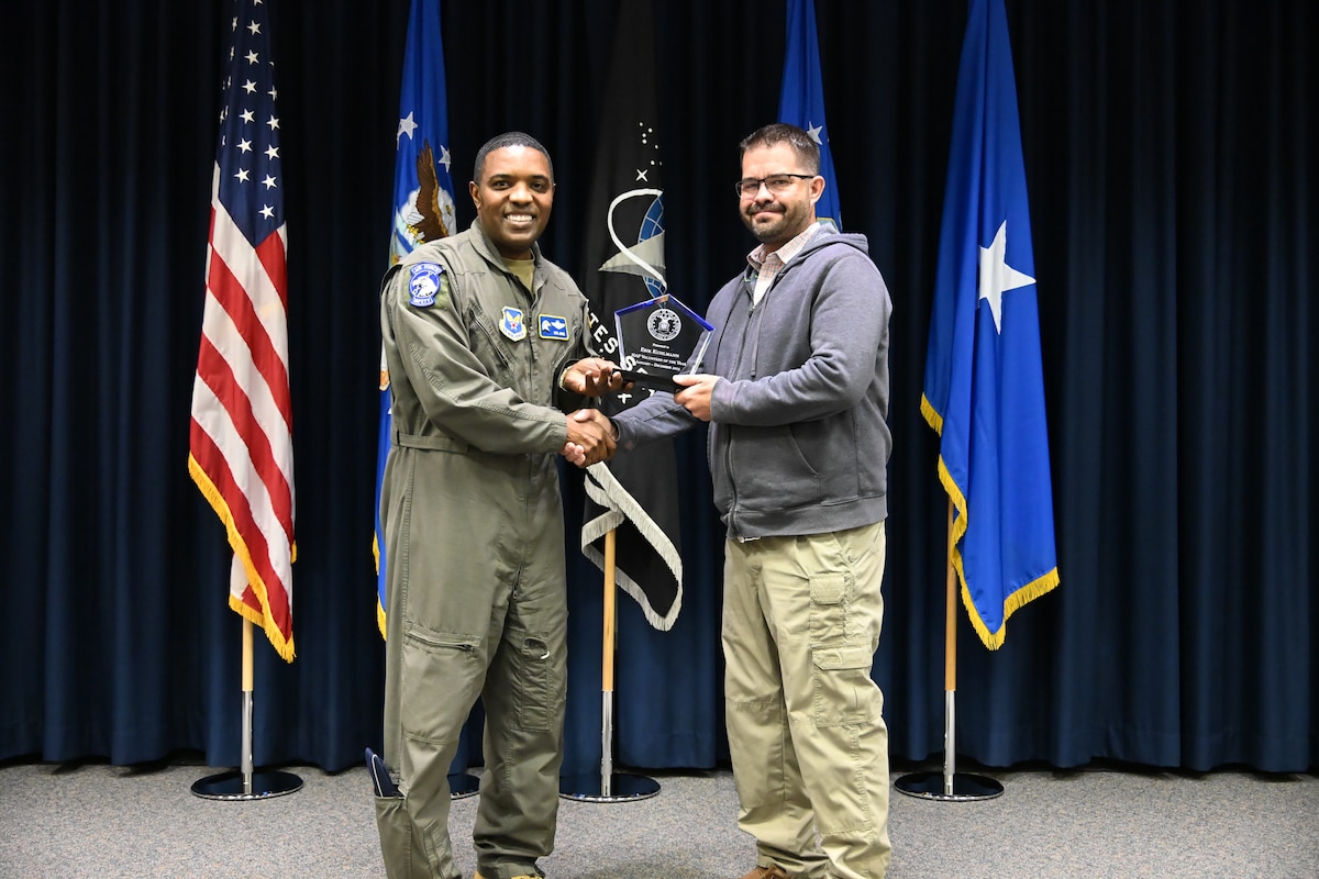 Brig. Gen. Otis Jones, commander of the Air Force Safety Center and Department of the Air Force chief of safety, presents Erik Kuhlmann, deputy chief of Aviation Safety Policy and Assurance, the DAF Volunteer of the Year Award on June 5, 2026.