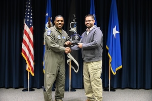 Brig. Gen. Otis Jones, commander of the Air Force Safety Center and Department of the Air Force chief of safety, presents Erik Kuhlmann, deputy chief of Aviation Safety Policy and Assurance, the DAF Volunteer of the Year Award on June 5, 2026.