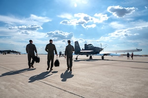 U.S. Air Force Col. Kyle Porter, 355th Wing deputy commander, and aircrew assigned to the 492nd Special Operations Wing approach an OA-1K Skyraider II aircraft at Davis-Monthan Air Force Base, Arizona, July 14, 2026. The knowledge and experience
gained during the familiarization flight ensures Porter can effectively support the 492nd SOW in his role as deputy commander. (U.S. Air Force photo by Senior
Airman Jasmyne Bridgers-Matos)