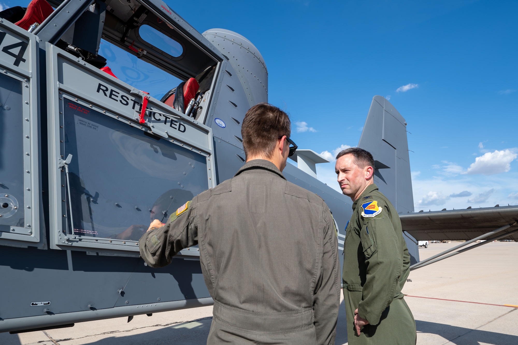 A U.S. Airman assigned to the 492nd Special
Operations Wing explains the mission of the OA-1K Skyraider II aircraft to Col. Kyle Porter, 355th Wing deputy commander, prior to a familiarization flight at Davis-Monthan Air Force Base, Arizona, July 14, 2026. The Skyraider II will provide special operations forces the ability to tailor effects to support the joint force delivering close air support, precision strike, and intelligence, surveillance and reconnaissance capability. (U.S. Air Force photo by Senior Airman Jasmyne Bridgers-Matos)