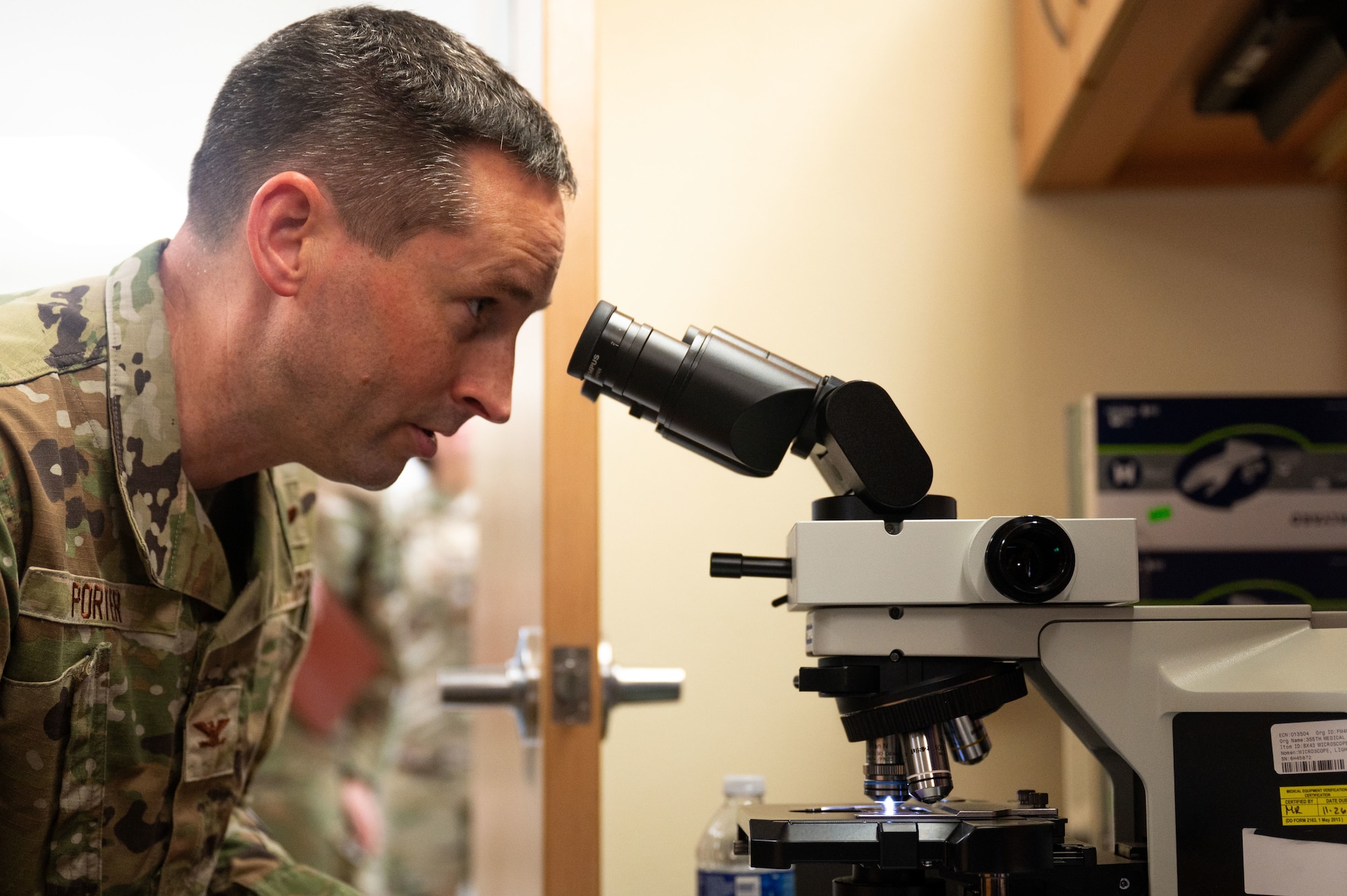 U.S. Air Force Col. Kyle Porter, 355th Wing deputy commander, looks through a microscope during an immersion tour of the 355th Medical Group at Davis-Monthan Air Force Base, Arizona, July 15, 2026. The tour provided Porter with a firsthand look at the medical group's capabilities and how it supports the health and readiness of Airmen across the wing. (U.S. Air Force photo by Airman 1st Class Jaden Kidd)
