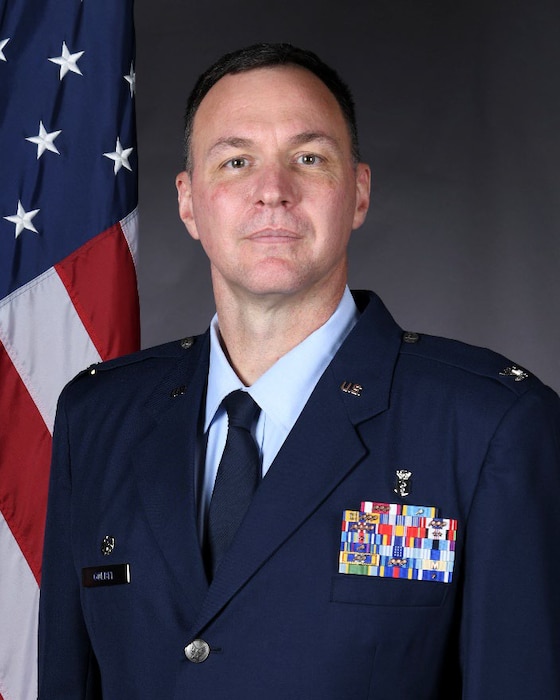 A man in Air force class A Uniform, poses for a photo