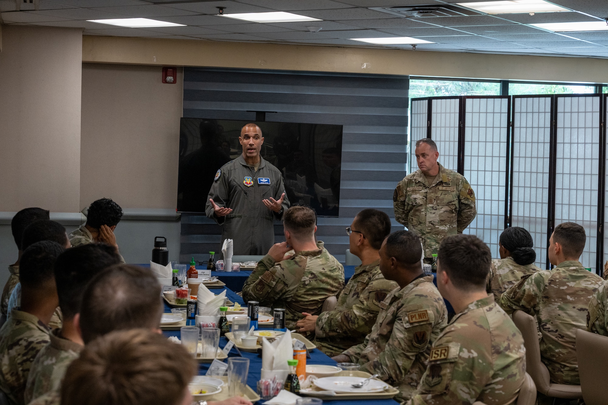 A commander speaks with Airmen over lunch.