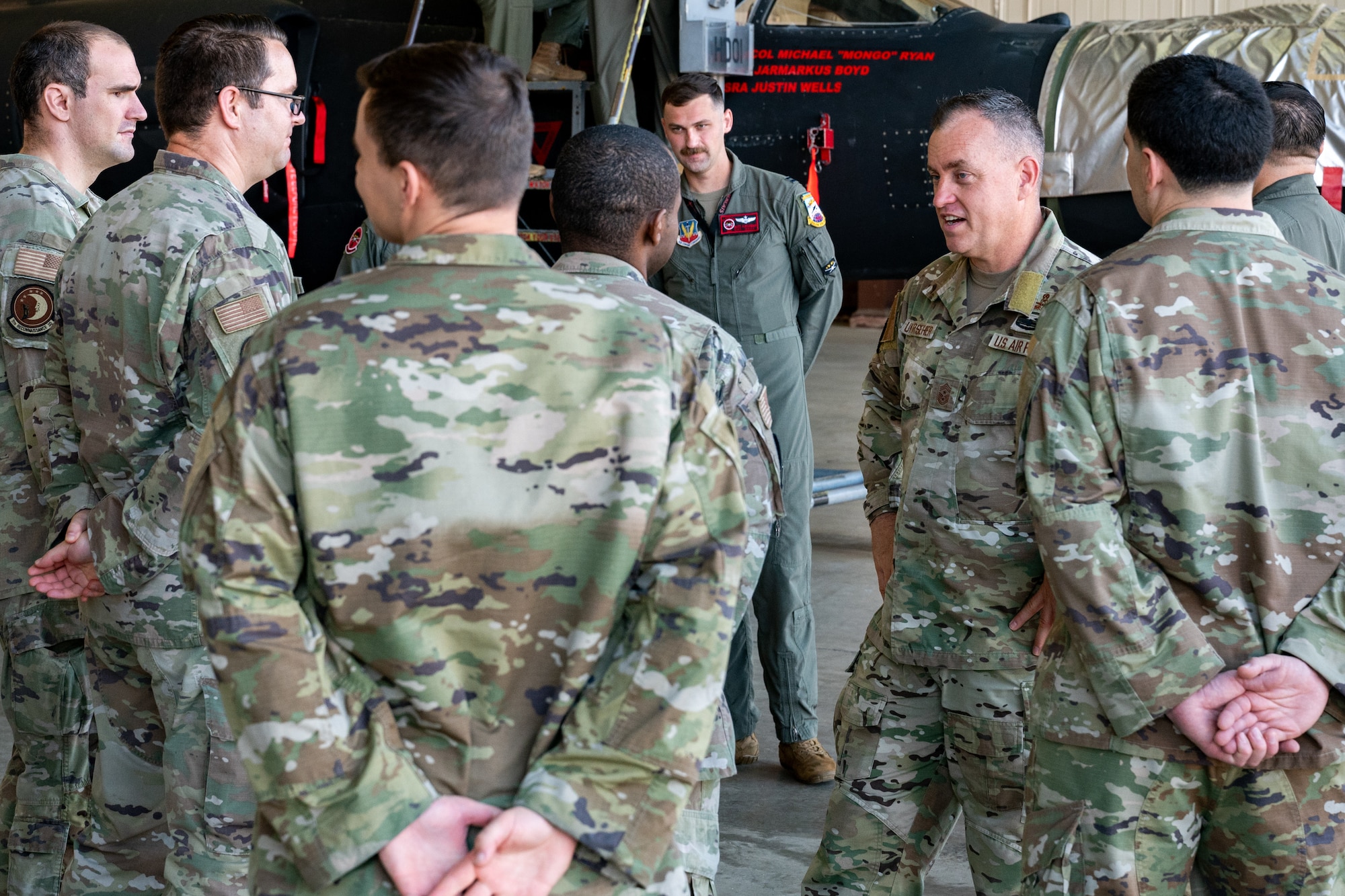 A command chief talks with Airmen during a tour.