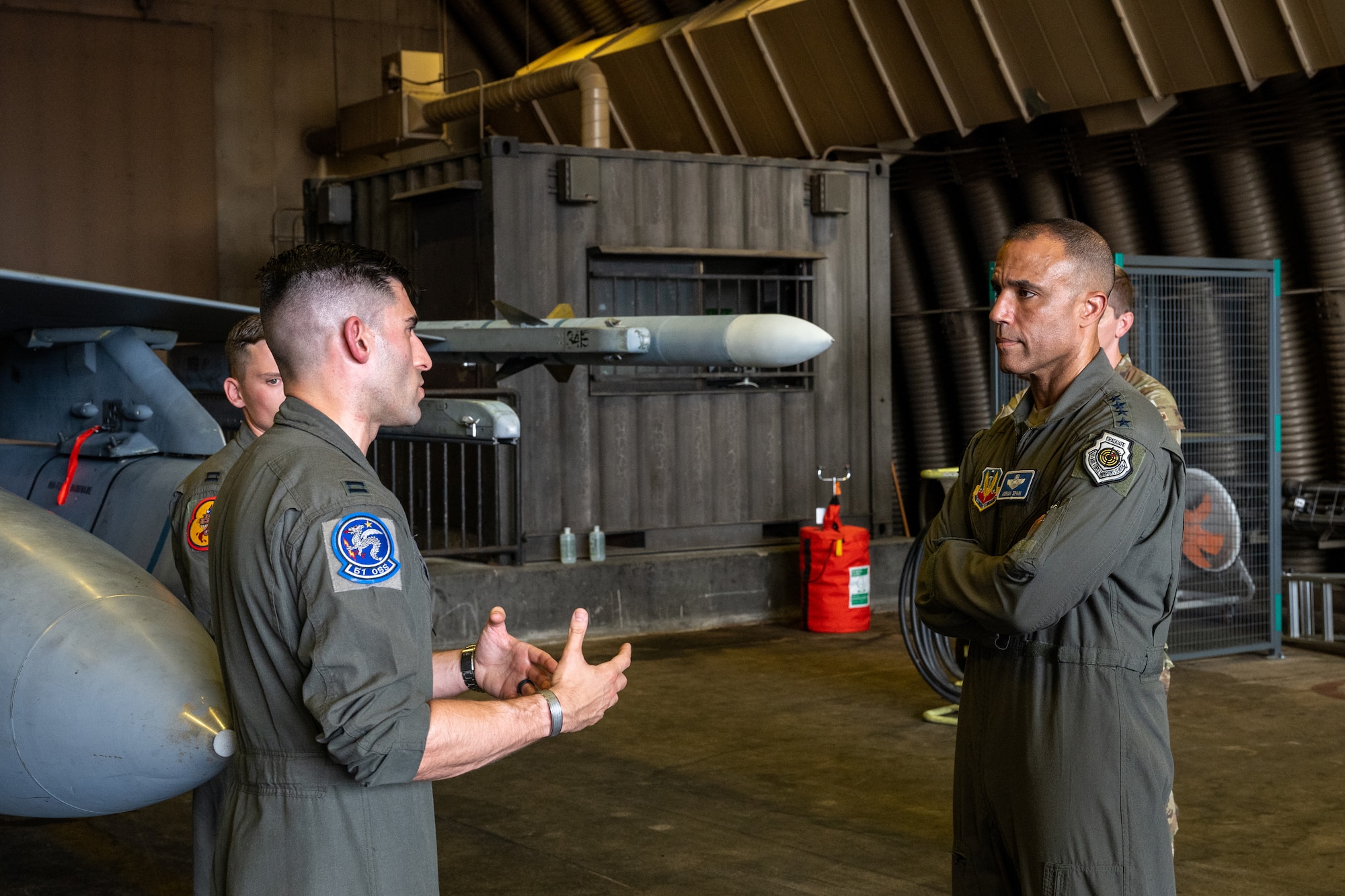 A pilot briefs a commander on regional capabilities.