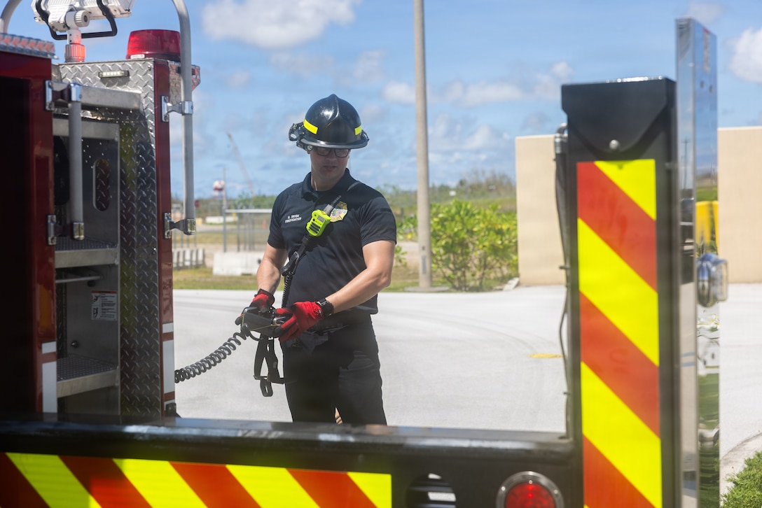 Harry Rehm, a firefighter with Marine Corps Base Camp Blaz, activates the stabilizers on a fire truck to perform a pump test on MCB Camp Blaz, Guam, June 9, 2026. The firefighters at Camp Blaz conduct regular training exercises to maintain operational readiness for all emergencies. (U.S. Marine Corps photo by Lance Cpl. Tanner Currin)