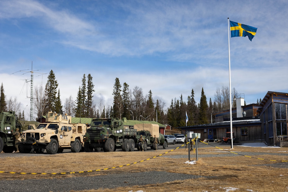 Medium tactical vehicle replacements and joint light tactical vehicles are staged during a long-range convoy during exercise Aurora 26 in Sweden, April 25, 2026. The long-range convoy from Værnes, Norway, to Sundsvall, Sweden, showcased CLB-24's unit readiness and interoperability with NATO Allies and partners. U.S. Marines and Sailors with 2nd MLG are participating in exercise Aurora as part of the larger U.S. Army-led Sword 26 series of linked multinational exercises, which directly supports NATO's Eastern Flank Deterrence Initiative concept, validates defense plans, builds a unified lethal force, and strengthens deterrence. (U.S. Marine Corps photo by Lance Cpl. Brady Hathaway)