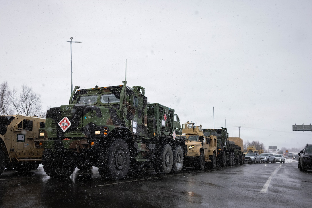 Medium tactical vehicle replacements and joint light tactical vehicles are staged for a long-range convoy during exercise Aurora 26 in Sweden, April 25, 2026. The long-range convoy from Værnes, Norway, to Sundsvall, Sweden, showcased CLB-24's unit readiness and interoperability with NATO Allies and partners. U.S. Marines and Sailors with 2nd MLG are participating in exercise Aurora as part of the larger U.S. Army-led Sword 26 series of linked multinational exercises, which directly supports NATO's Eastern Flank Deterrence Initiative concept, validates defense plans, builds a unified lethal force, and strengthens deterrence. (U.S. Marine Corps photo by Lance Cpl. Brady Hathaway)