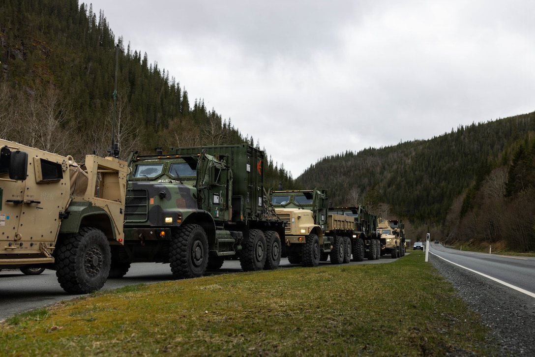 Medium tactical vehicle replacements and joint light tactical vehicles are staged for a long-range convoy during exercise Aurora 26 in Norway, April 25, 2026. U.S. Marines and Sailors with 2nd MLG are participating in exercise Aurora as part of the larger U.S. Army-led Sword 26 series of linked multinational exercises, which directly supports NATO's Eastern Flank Deterrence Initiative concept, validates defense plans, builds a unified lethal force, and strengthens deterrence. (U.S. Marine Corps photo by Lance Cpl. Brady Hathaway)