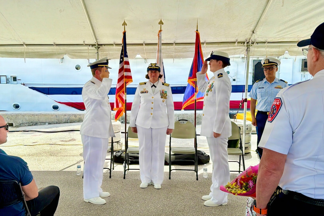 Lt. Drew Lovullo assumes command of USCGC Myrtle Hazard (WPC 1139) from Lt. Emma Saunders in a change of command ceremony on Victor Wharf in Guam on July 17, 2026. Capt. Jessica Worst, commander of U.S. Coast Guard Forces Micronesia/Sector Guam, presided over the ceremony. Under Saunders' command, Myrtle Hazard’s crew recently delivered roughly 20,000 pounds of relief supplies to five islands across the Commonwealth of the Northern Mariana Islands after Super Typhoon Sinlaku, carrying the mayor of Agrihan and Pagan to his constituents and moving equipment for Navy partners. Weeks later, after Super Typhoon Bavi, the crew ferried aids to navigation and Navy Explosive Ordnance Disposal teams across the Marianas, running sonar assessments off Rota and supporting the assessments that reopened the ports of Tinian and Rota. (U.S. Coast Guard photo by Lt. Sara Muir)