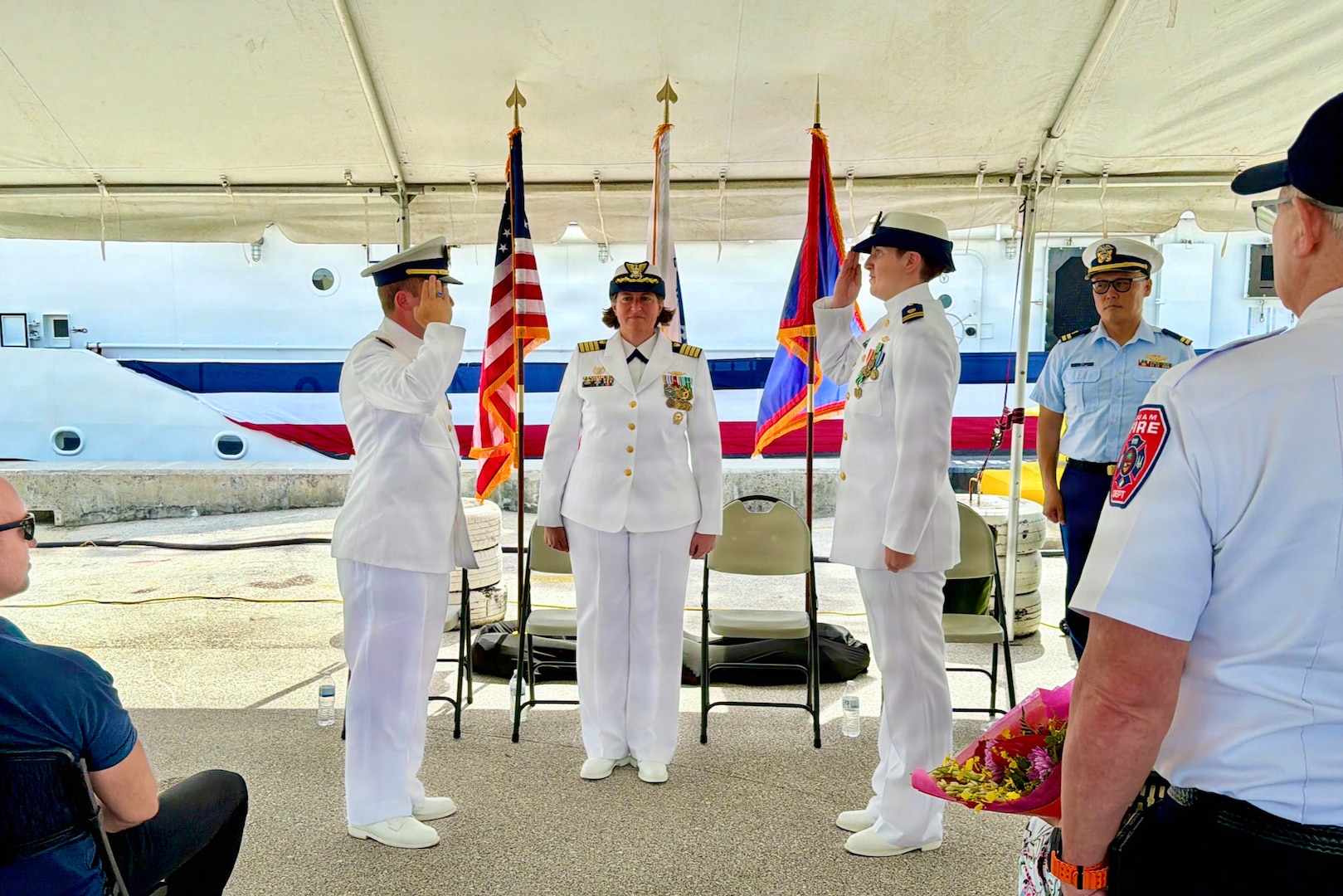 Lt. Drew Lovullo assumes command of USCGC Myrtle Hazard (WPC 1139) from Lt. Emma Saunders in a change of command ceremony on Victor Wharf in Guam on July 17, 2026. Capt. Jessica Worst, commander of U.S. Coast Guard Forces Micronesia/Sector Guam, presided over the ceremony. Under Saunders' command, Myrtle Hazard’s crew recently delivered roughly 20,000 pounds of relief supplies to five islands across the Commonwealth of the Northern Mariana Islands after Super Typhoon Sinlaku, carrying the mayor of Agrihan and Pagan to his constituents and moving equipment for Navy partners. Weeks later, after Super Typhoon Bavi, the crew ferried aids to navigation and Navy Explosive Ordnance Disposal teams across the Marianas, running sonar assessments off Rota and supporting the assessments that reopened the ports of Tinian and Rota. (U.S. Coast Guard photo by Lt. Sara Muir)