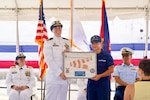 Lt. Drew Lovullo assumes command of USCGC Myrtle Hazard (WPC 1139) from Lt. Emma Saunders in a change of command ceremony on Victor Wharf in Guam on July 17, 2026. Capt. Jessica Worst, commander of U.S. Coast Guard Forces Micronesia/Sector Guam, presided over the ceremony. Under Saunders' command, Myrtle Hazard’s crew recently delivered roughly 20,000 pounds of relief supplies to five islands across the Commonwealth of the Northern Mariana Islands after Super Typhoon Sinlaku, carrying the mayor of Agrihan and Pagan to his constituents and moving equipment for Navy partners. Weeks later, after Super Typhoon Bavi, the crew ferried aids to navigation and Navy Explosive Ordnance Disposal teams across the Marianas, running sonar assessments off Rota and supporting the assessments that reopened the ports of Tinian and Rota. (U.S. Coast Guard photo by Lt. Sara Muir)