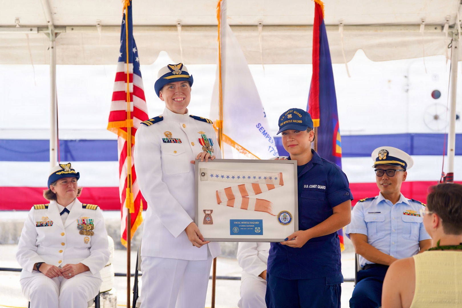 Lt. Drew Lovullo assumes command of USCGC Myrtle Hazard (WPC 1139) from Lt. Emma Saunders in a change of command ceremony on Victor Wharf in Guam on July 17, 2026. Capt. Jessica Worst, commander of U.S. Coast Guard Forces Micronesia/Sector Guam, presided over the ceremony. Under Saunders' command, Myrtle Hazard’s crew recently delivered roughly 20,000 pounds of relief supplies to five islands across the Commonwealth of the Northern Mariana Islands after Super Typhoon Sinlaku, carrying the mayor of Agrihan and Pagan to his constituents and moving equipment for Navy partners. Weeks later, after Super Typhoon Bavi, the crew ferried aids to navigation and Navy Explosive Ordnance Disposal teams across the Marianas, running sonar assessments off Rota and supporting the assessments that reopened the ports of Tinian and Rota. (U.S. Coast Guard photo by Lt. Sara Muir)