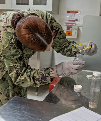 YOKOSUKA, Japan (June 16, 2026) Hospital Corpsman 3rd Class Casandra Tisdale, a preventive medicine technician assigned to U.S. Naval Hospital Yokosuka's Directorate for Public Health (DPH), prepares a collected water sample for laboratory analysis aboard. DPH worked with Commander, Fleet Activities Yokosuka Public Works and environmental partners to verify the installation's drinking water system met U.S. and Japanese safety standards following water line repairs. (U.S. Navy photo by Daniel Taylor/USNH Yokosuka Public Affairs)