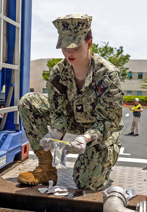YOKOSUKA, Japan (June 16, 2026) Hospital Corpsman 3rd Class Casandra Tisdale, a preventive medicine technician assigned to U.S. Naval Hospital Yokosuka's Directorate for Public Health (DPH) collects a water sample from a tanker. DPH collected samples from multiple locations across the installation to support water quality testing following repairs to the installation's water distribution system. (U.S. Navy photo by Daniel Taylor/USNH Yokosuka Public Affairs)
