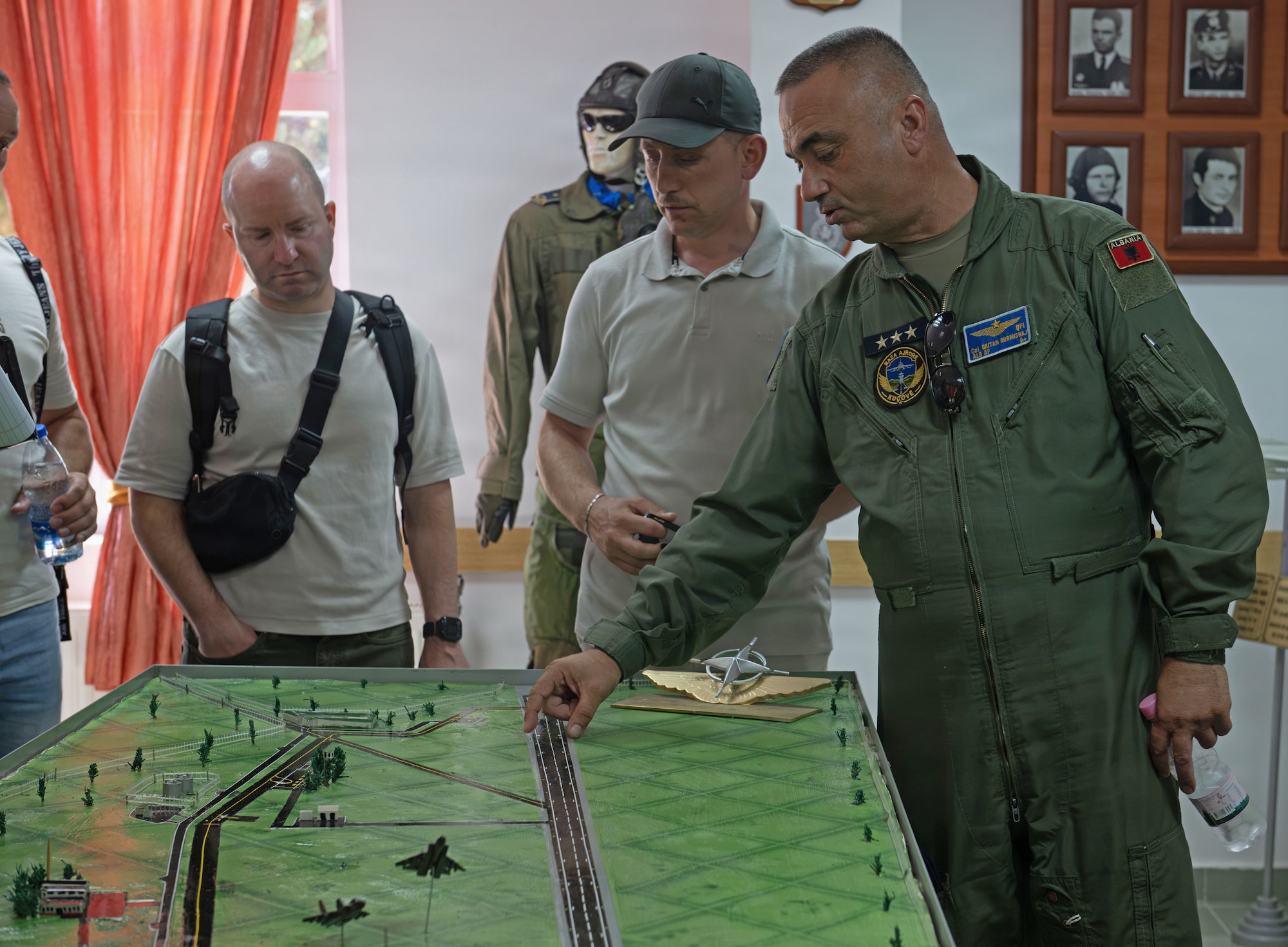 Albanian Air Force Col. Oritan Durmishaj, Kuçovë Air Base commander provides a historical briefing to members of the European Partnership Flight - Tirana, sharing the evolution of Albania's air force and its journey toward greater integration with NATO partners at Kuçovë Air Base, Albania
