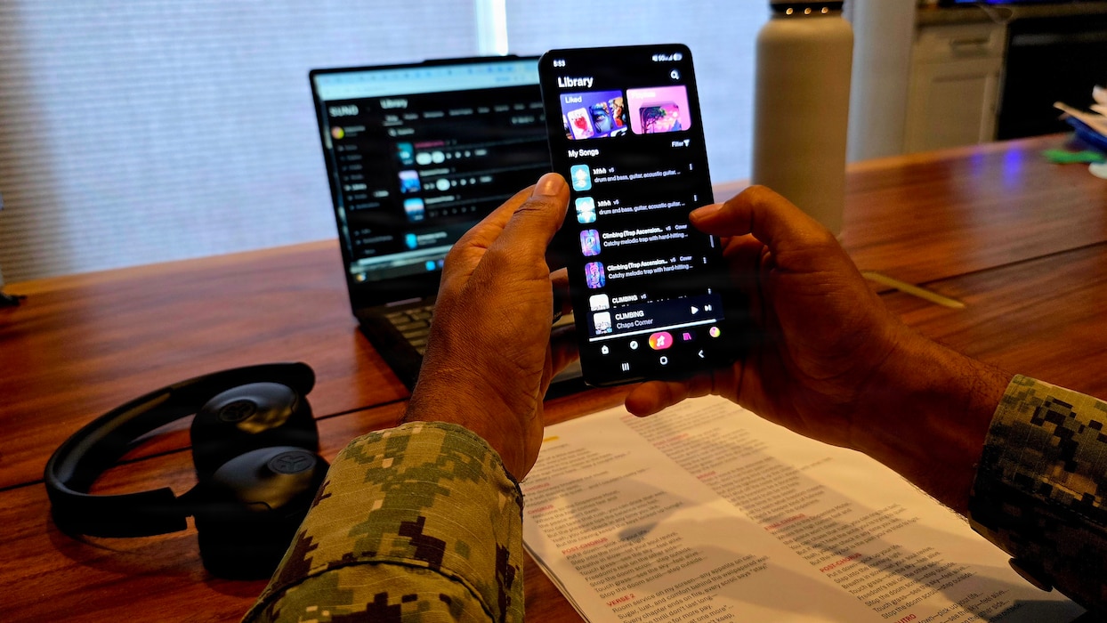 Lt. Cmdr. Abraham Jiregna organizes his catalog of AI-assisted music at Navy Medicine Readiness and Training Command San Diego, May 27, 2026. Jiregna, a clinical pastoral education resident chaplain, has generated more than 300 original songs to support his music-informed spiritual care sessions, helping service members process emotional and spiritual challenges. (Courtesy photo)