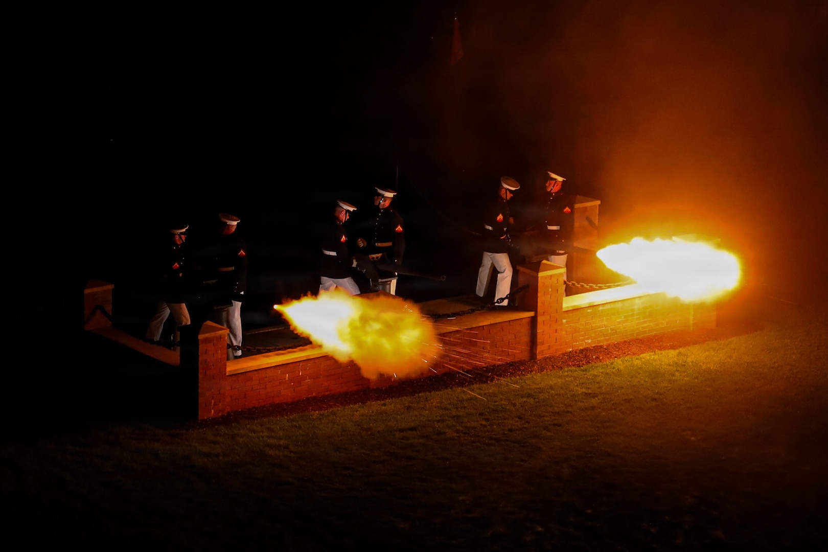 The United States Marine Corps Body Bearers, Bravo Company, Marine Barracks Washington, fire ceremonial cannons during an Evening Parade at Marine Barracks Washington, D.C., July 10, 2026. (U.S. Marine Corps photo by Lance Cpl. Landon Heredia).