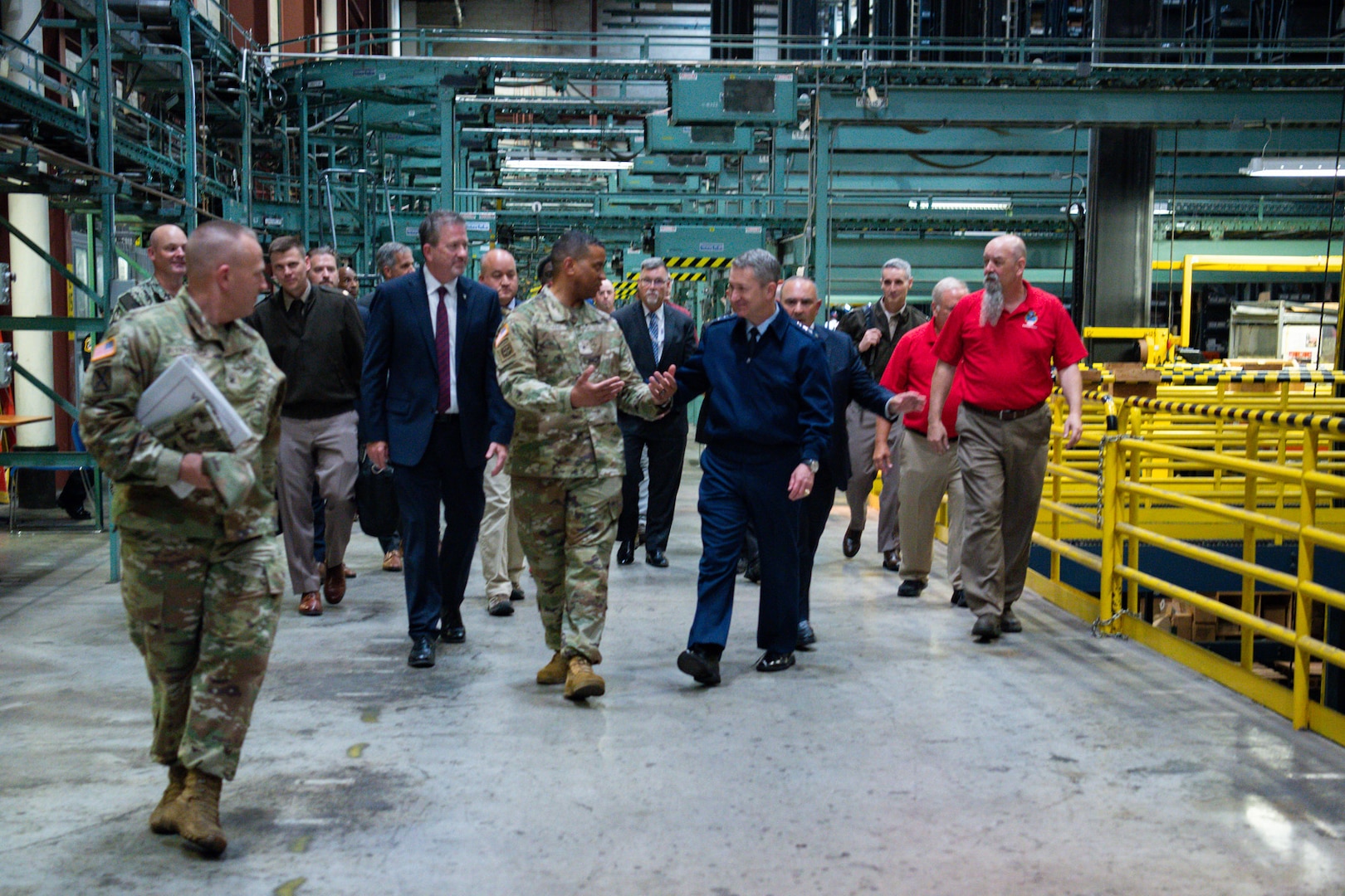 People walking in a DLA Distribution warehouse.