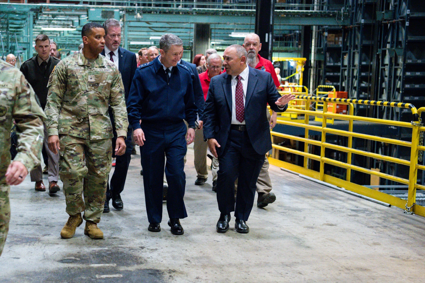 People walking in a DLA Distribution warehouse.