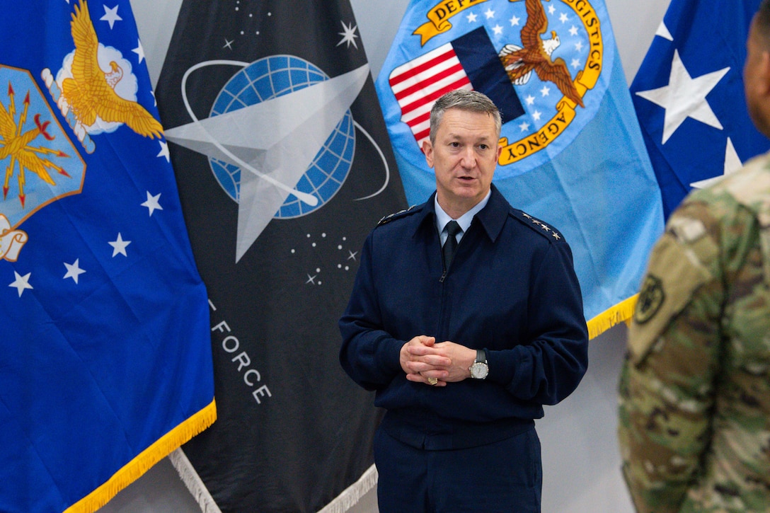Air Force General Officer in front of flags.