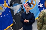 Air Force General Officer in front of flags.