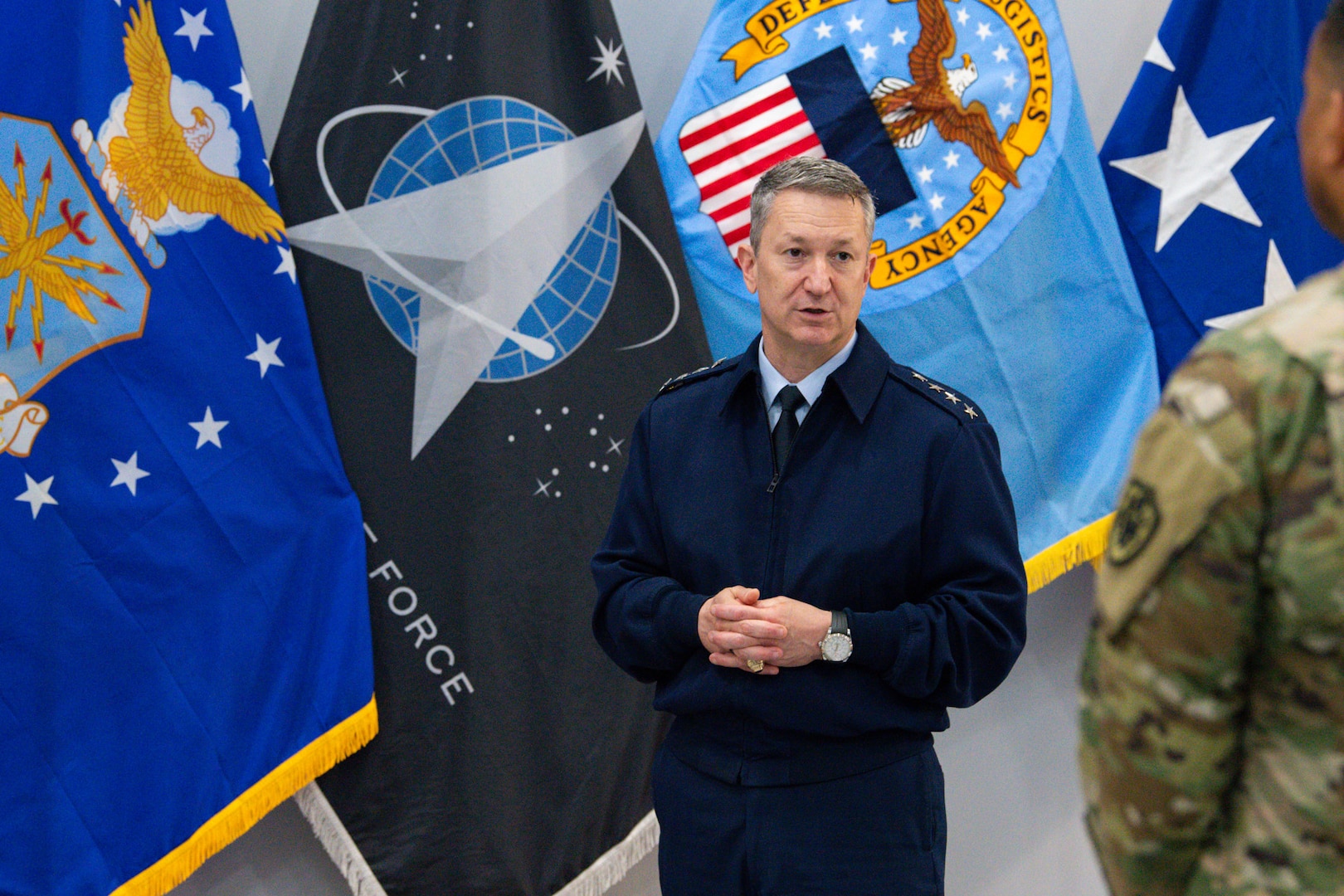 Air Force General Officer in front of flags.