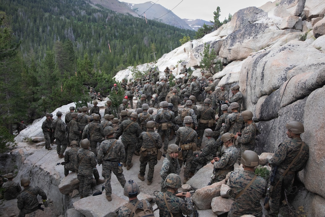 U.S. Marine Corps Sgt. Alexander Day, a mountain warfare instructor, teaches Marines with 3rd Battalion, 25th Marine Regiment, 4th Marine Division, how to conduct suspension and traversal techniques prior to a 8k cliff assault practical application during Mountain Training Exercise (MTX) 26-3 at Marine Corps Mountain Warfare Training Center, Bridgeport, California, July 12, 2026. MTX is an annual two-week training evolution that is designed to strengthen unit cohesion and prepare the battalion for rapid mobilization in support of future global operations. (U.S. Marine Corps photo by Cpl. Orion Stpierre)