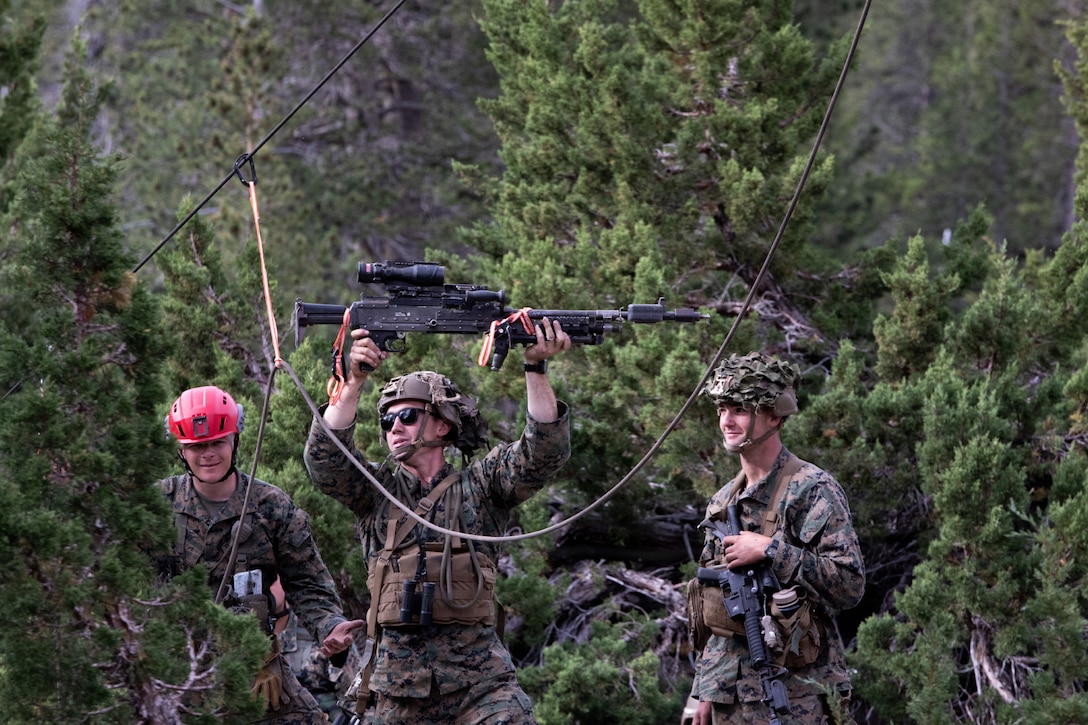 U.S. Marine Corps Sgt. Alexander Day, a mountain warfare instructor, teaches Marines with 3rd Battalion, 25th Marine Regiment, 4th Marine Division, how to conduct suspension and traversal techniques prior to a 8k cliff assault practical application during Mountain Training Exercise (MTX) 26-3 at Marine Corps Mountain Warfare Training Center, Bridgeport, California, July 12, 2026. MTX is an annual two-week training evolution that is designed to strengthen unit cohesion and prepare the battalion for rapid mobilization in support of future global operations. (U.S. Marine Corps photo by Cpl. Orion Stpierre)