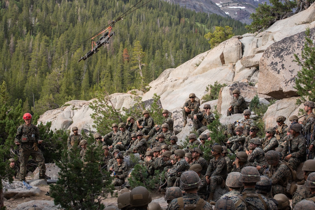 U.S. Marine Corps Sgt. Alexander Day, a mountain warfare instructor, teaches Marines with 3rd Battalion, 25th Marine Regiment, 4th Marine Division, how to conduct suspension and traversal techniques prior to a 8k cliff assault practical application during Mountain Training Exercise (MTX) 26-3 at Marine Corps Mountain Warfare Training Center, Bridgeport, California, July 12, 2026. MTX is an annual two-week training evolution that is designed to strengthen unit cohesion and prepare the battalion for rapid mobilization in support of future global operations. (U.S. Marine Corps photo by Cpl. Orion Stpierre)