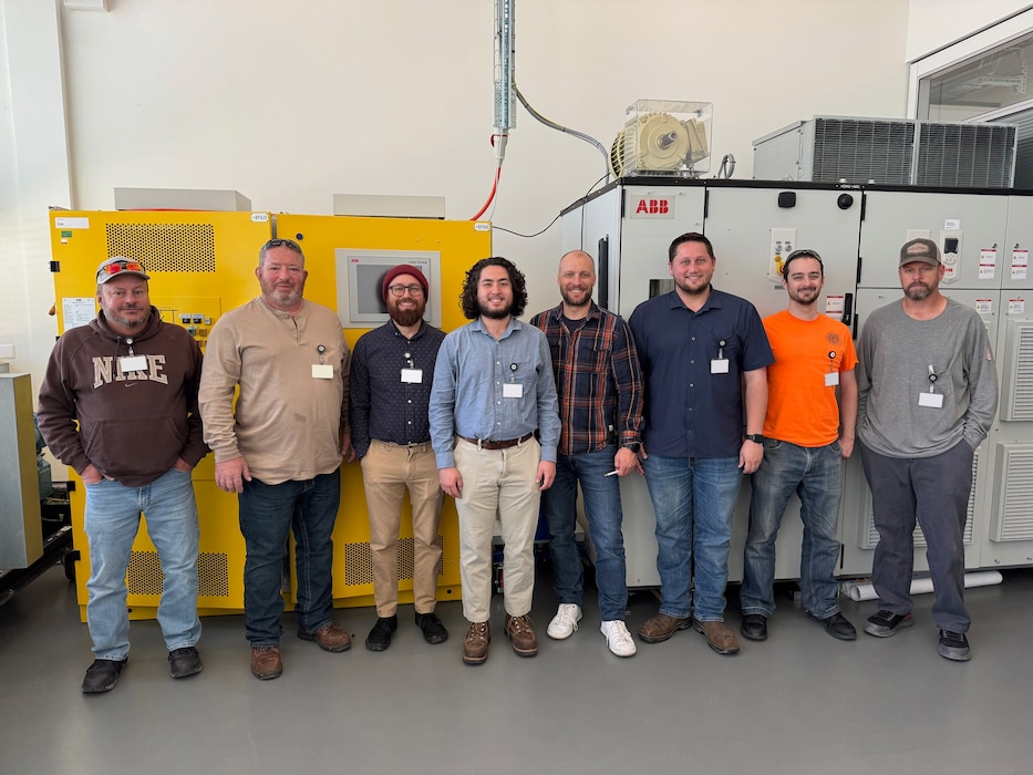 The team of Arnold Engineering Development Complex professionals who recently traveled to Turgi, Switzerland, pose for a photo. During their visit, the team completed factory acceptance testing and training for the Engine Test Facility Plant Variable Frequency Starter System. Pictured left to right, are Rocco Simeri, Kenneth Taylor, Albert Velazquez, Travis Smith, ABB lead trainer Razvan Coman, John Bearden, James Rogers, and Zachary Grosch. (Courtesy photo)