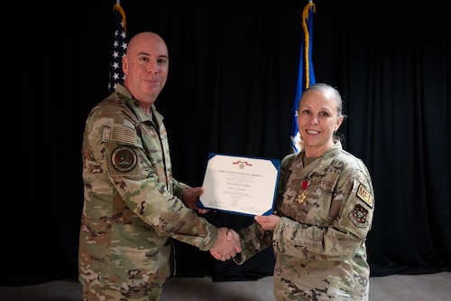 Eric Bissonette presents the Legion of Merit Medal to Col. Kelly Vermillion.