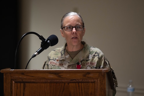 Col. Kelly Vermillion delivers remarks at a podium.