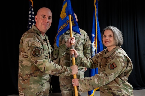 Col. Eric Bissonette presents the Laughlin Medical Group guidon to Col. Diane Caranta.