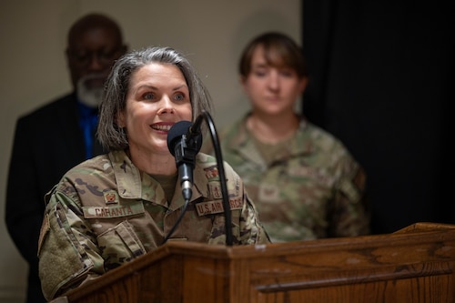 Col. Diane Caranta delivers remarks at a podium.